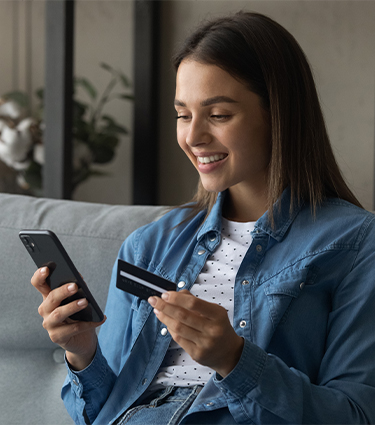 Girl with mobile phone and check card